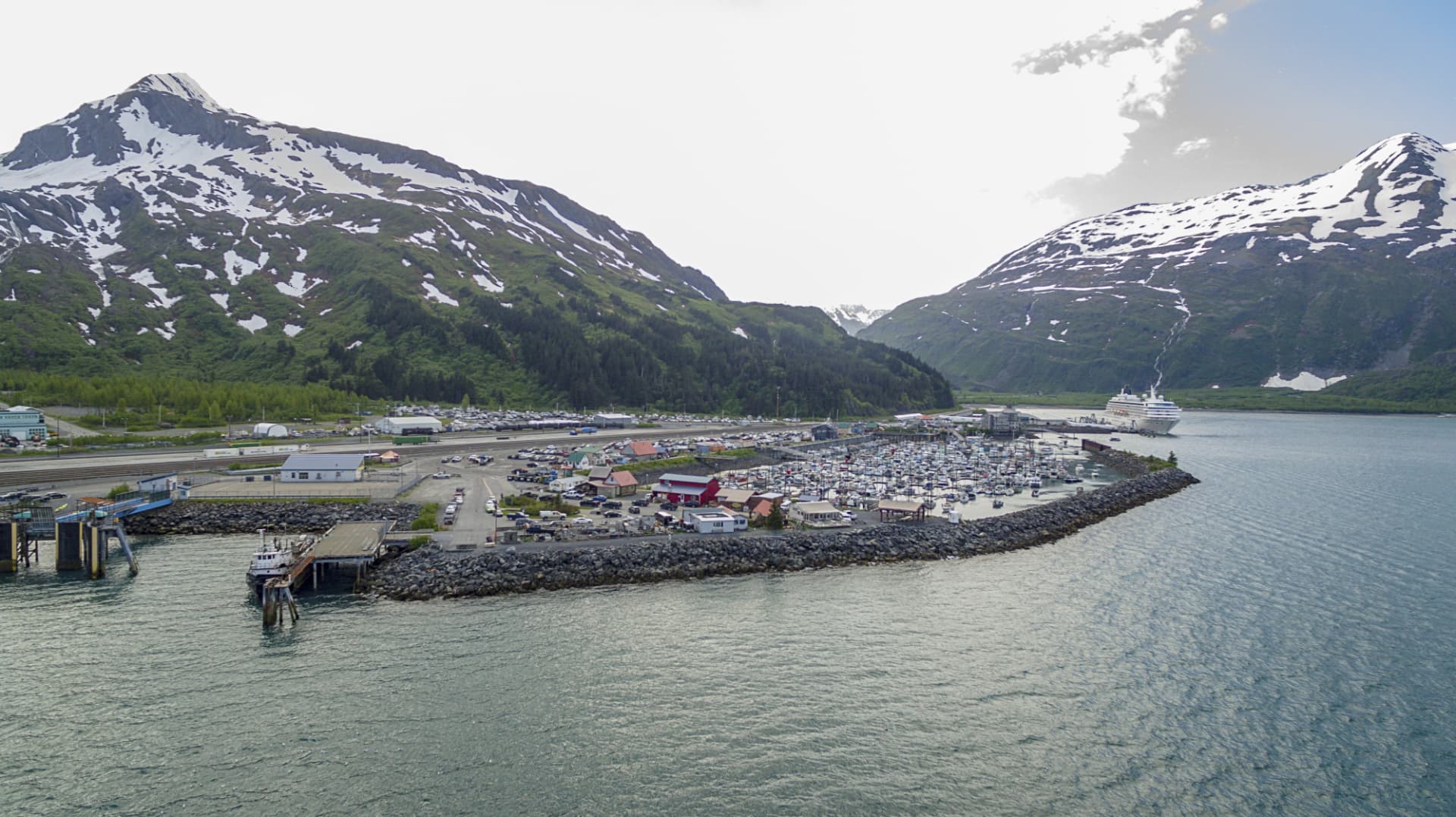Whittier harbor with a cruise ship and surrounding mountains