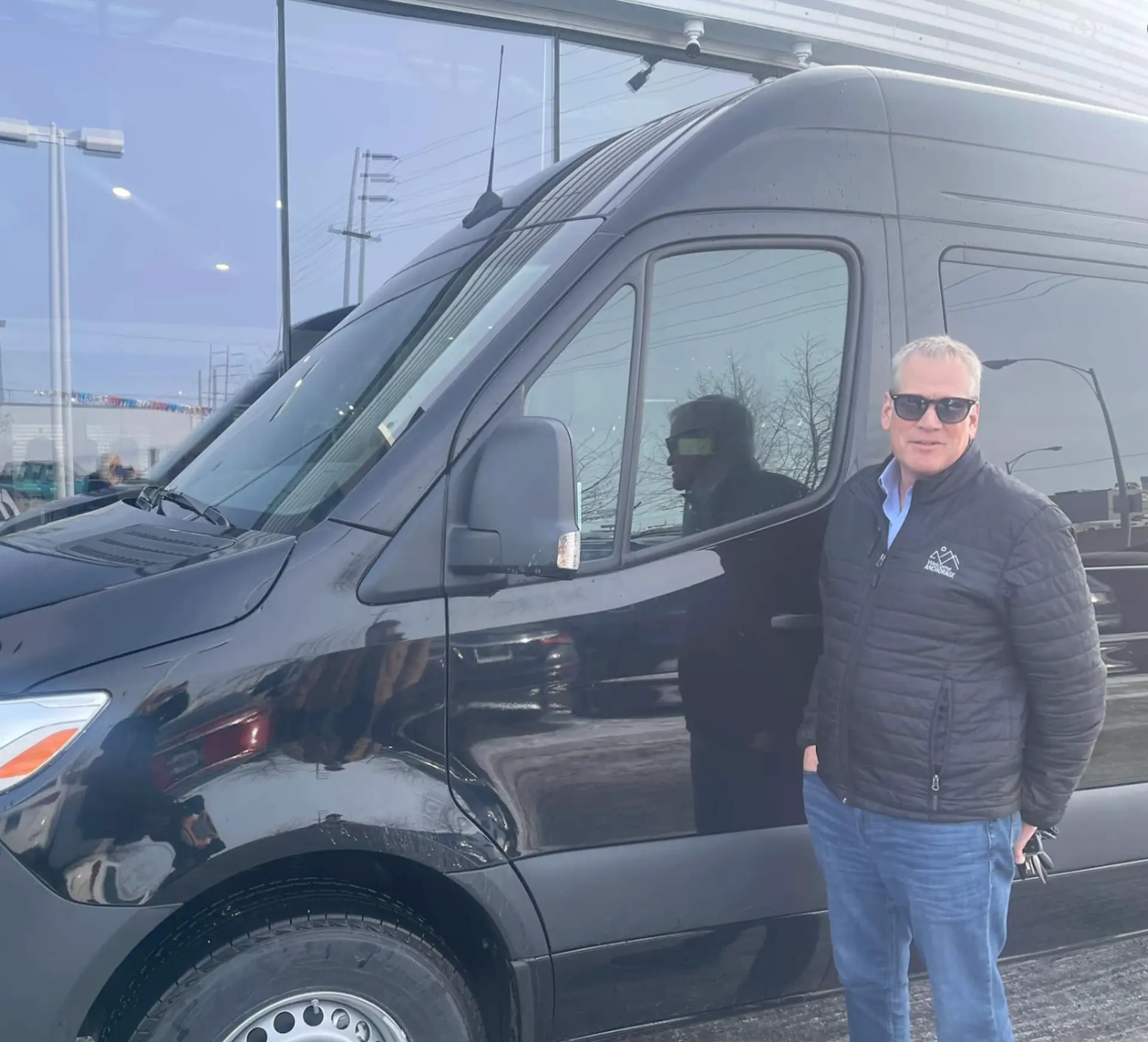 Driver beside the private transfer van
